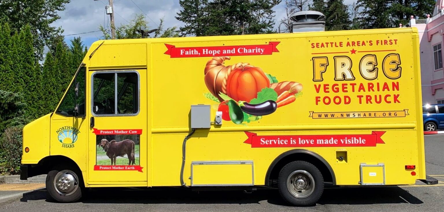 The yellow Northwest SHARE free vegetarian food truck, side view